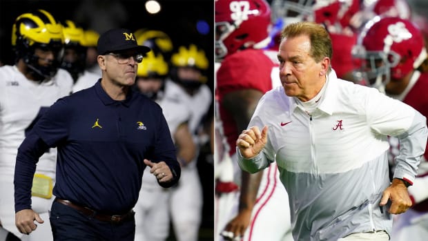 Jim Harbaugh and Nick Saban running out of the tunnel.
